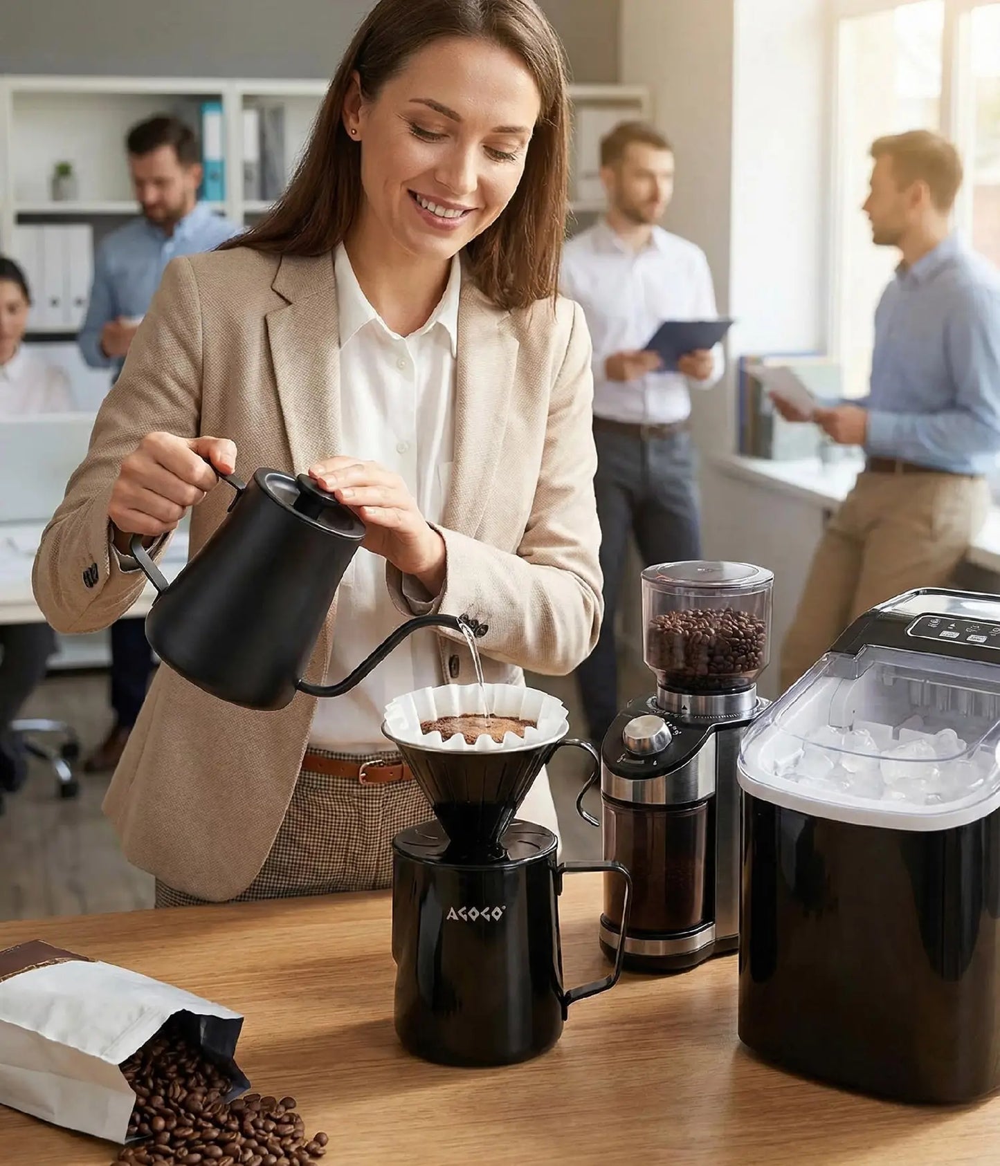 Smiling professional woman preparing a clean, fresh brew with the generous 900ml AGOGO matte black stainless pour over maker in a modern office pantry, ready to share with colleagues.