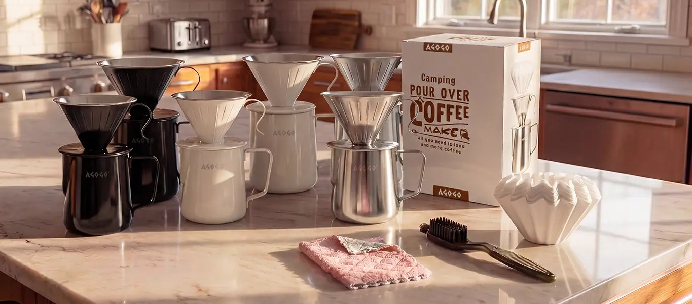 AGOGO stainless steel camping pour over coffee maker gift set on a kitchen counter, displaying carafes in three colors, paper filters, a cleaning brush, towel, and premium packaging.