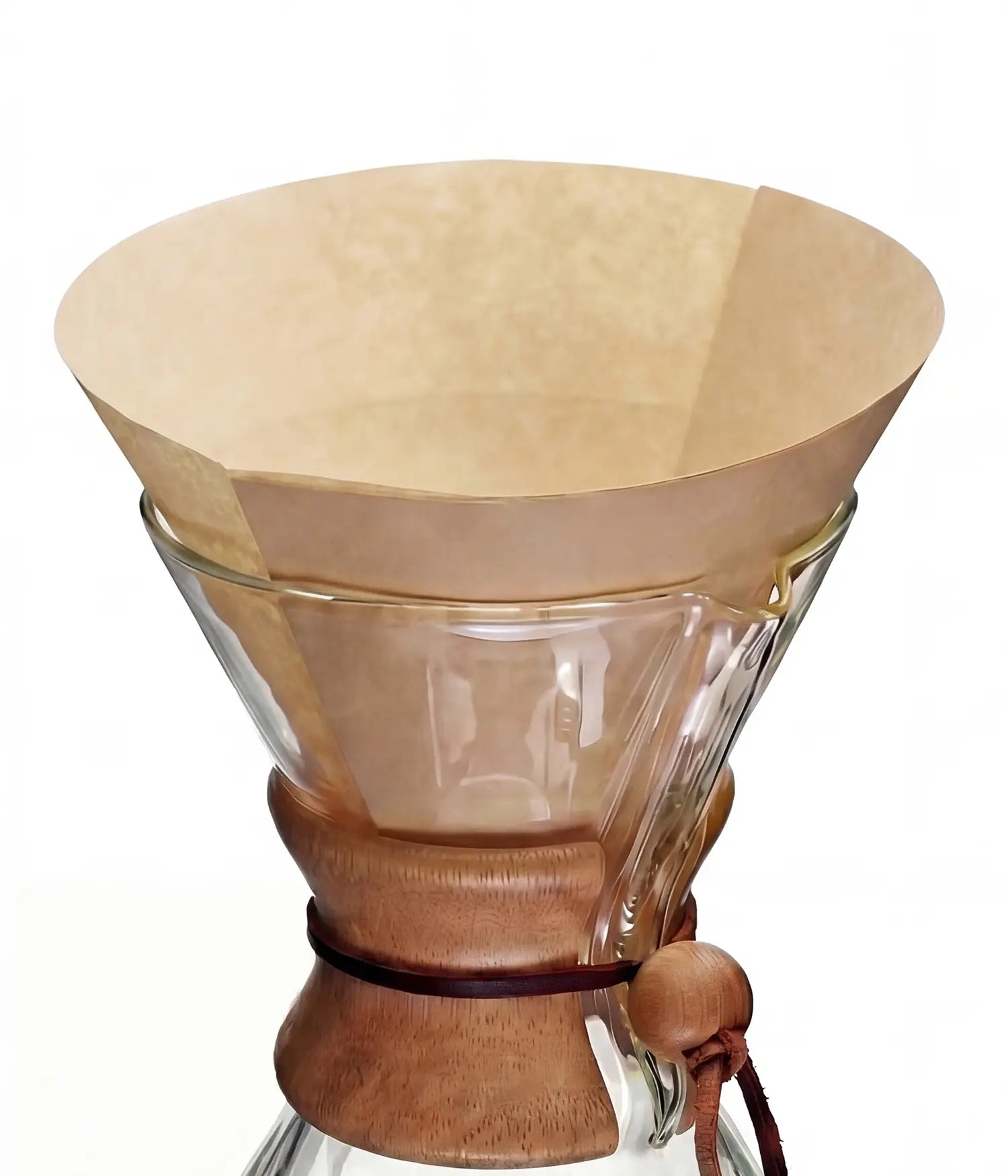 A natural brown 25cm circle pre-folded coffee filter sitting perfectly inside a classic glass pour-over coffee maker.