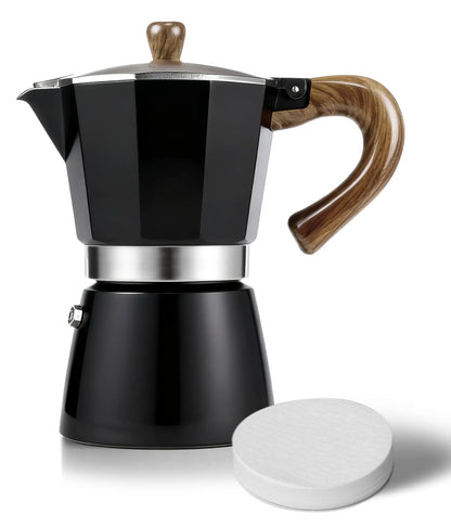 A sleek matte black AGOGO Milano Moka Pot with a wood-style handle, displayed next to a precision paper filter on a pure white background.