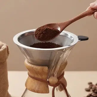 Step 1 of brewing with the AGOGO pour over coffee maker: adding medium-coarse ground coffee into the dual-layer stainless steel or paper filter.
