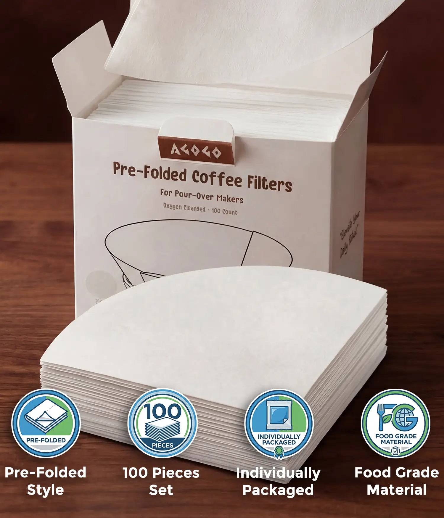 A hand taking a pure white circular coffee filter from the AGOGO 100-count value box, with a stack of oxygen-cleansed half-moon pre-folded filters resting on a wooden table.