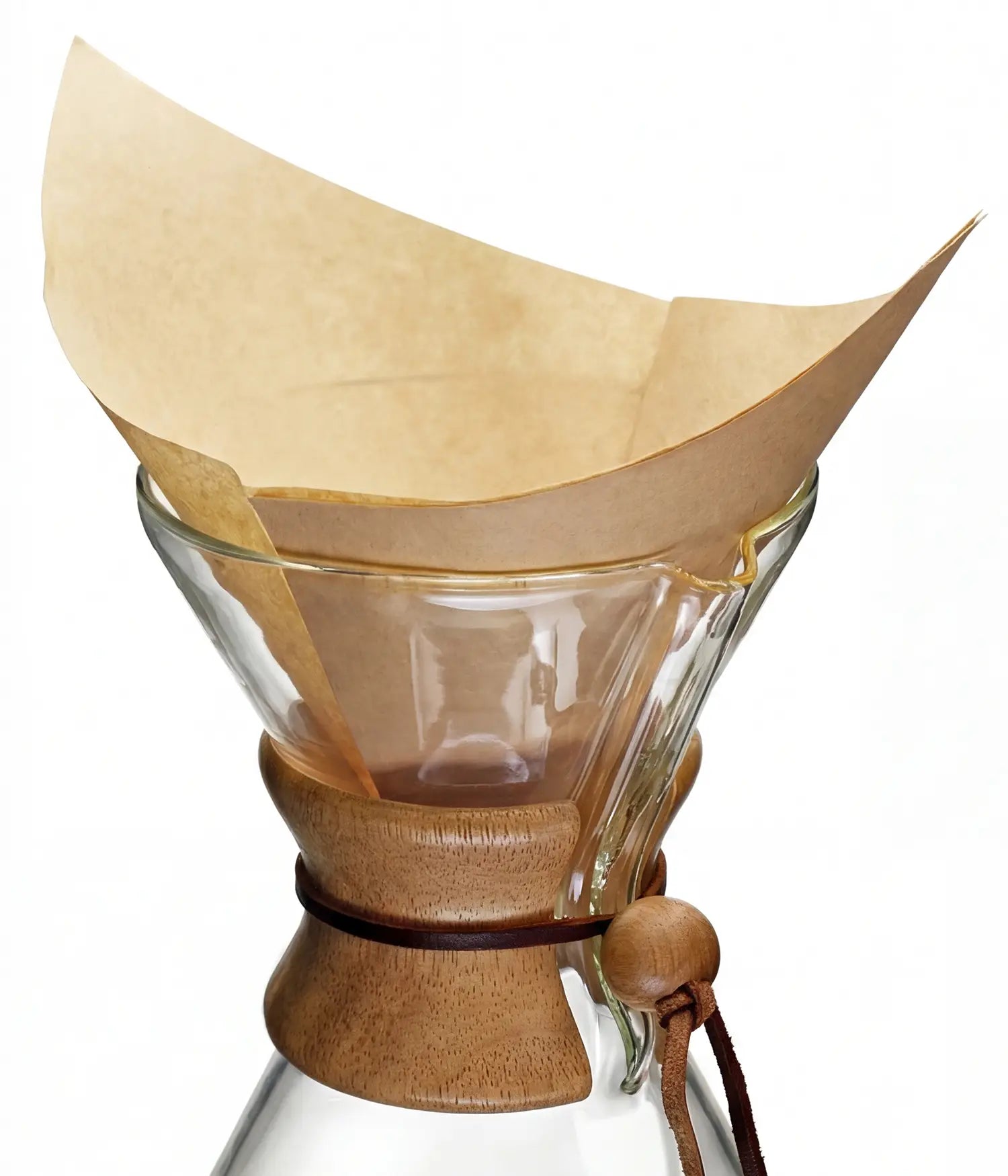 A natural brown 30x30cm square pre-folded coffee filter sitting perfectly inside a classic glass pour-over coffee maker.
