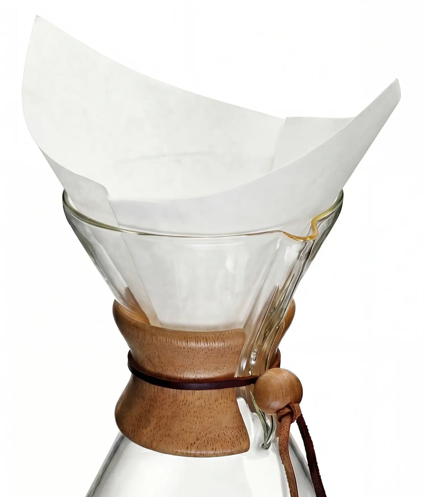 A pure white 30x30cm square pre-folded coffee filter sitting perfectly inside a classic glass pour-over coffee maker.