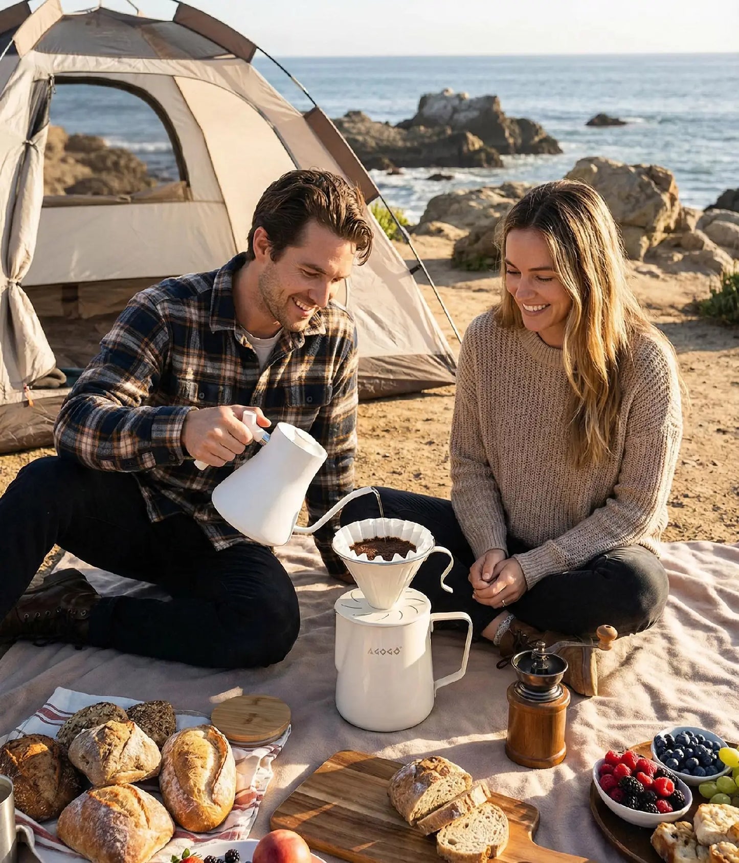Happy couple enjoying a coastal beach camping trip by their tent, brewing fresh coffee with the highly durable, large capacity 900ml AGOGO warm cream stainless steel pour over maker.
