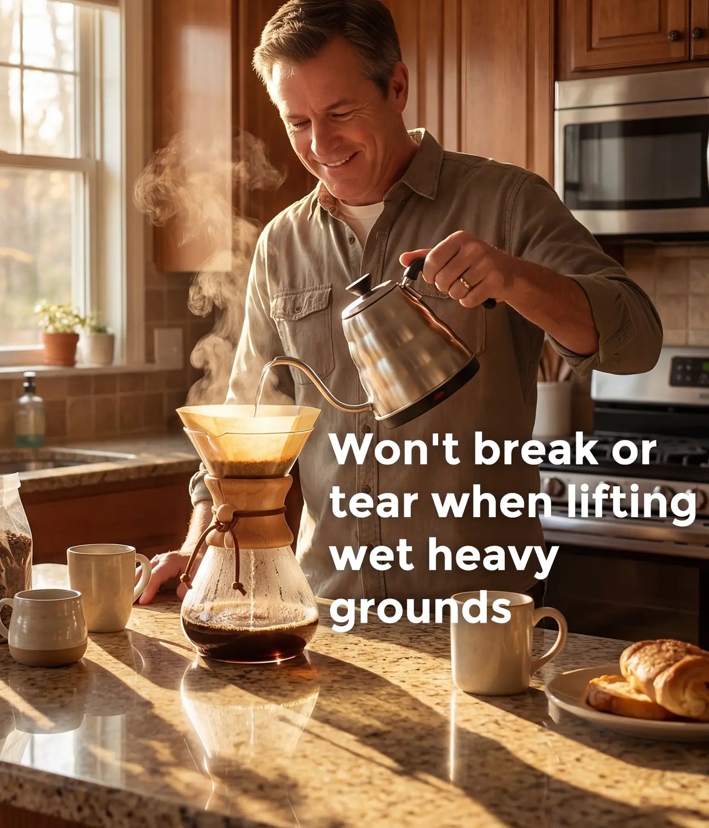 A smiling man in a sunny kitchen pouring hot water from a gooseneck kettle into an AGOGO natural brown circle coffee filter, highlighting its tear-resistant design.