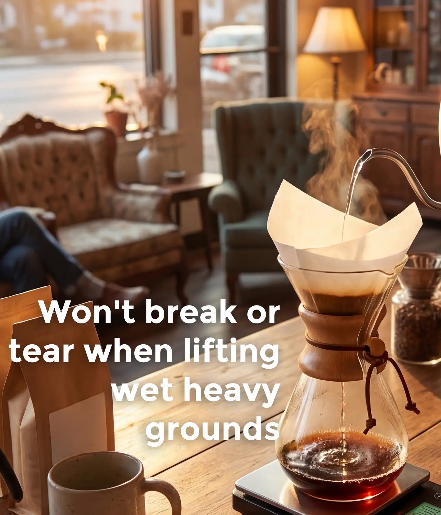 Hot water pouring from a gooseneck kettle into an AGOGO pure white square coffee filter, demonstrating its tear-resistant design in a cozy setting.